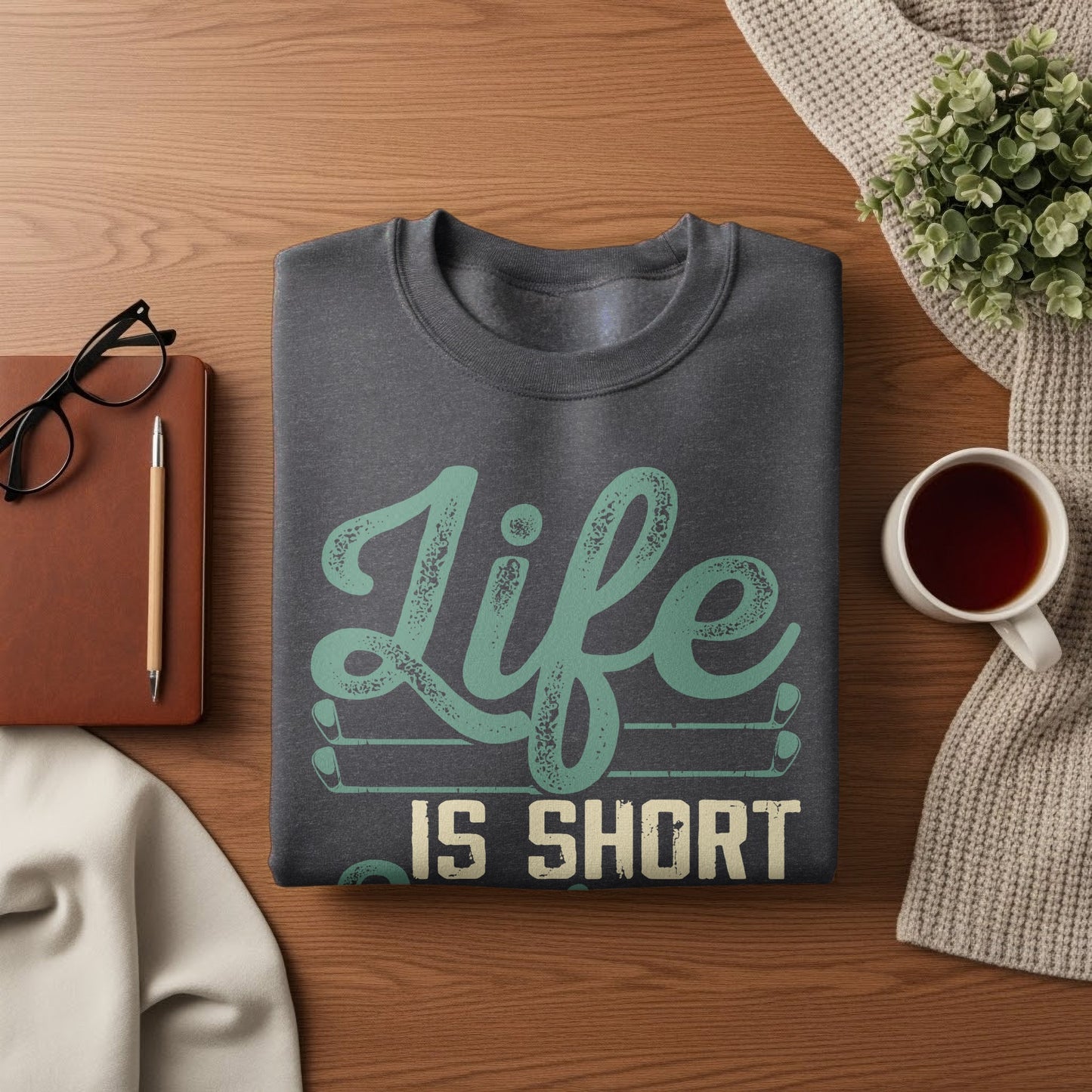 Dark gray sweatshirt with "Life IS SHORT" text and golf club graphic.