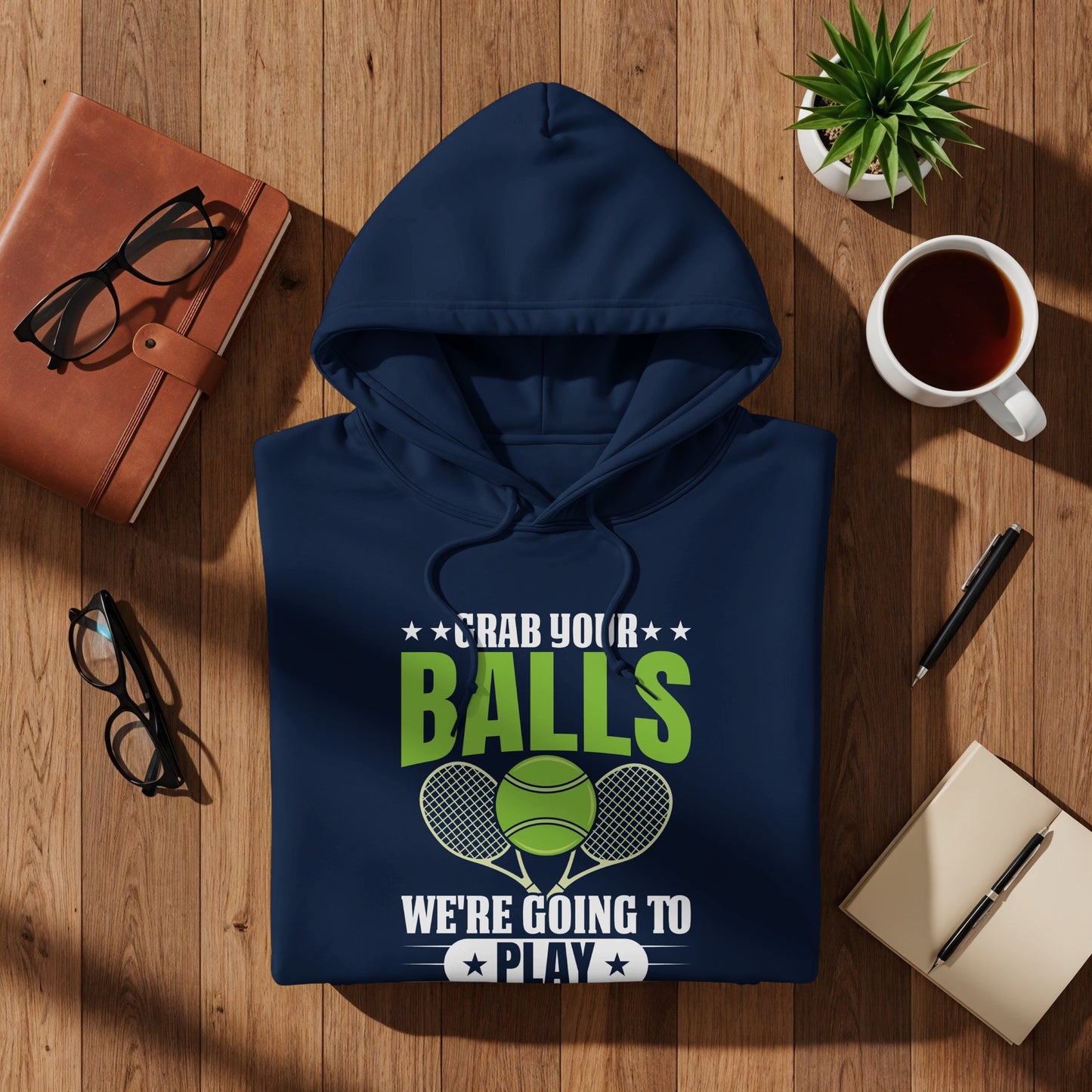 Navy hoodie with "Grab Your Balls We're Going to Play" text and tennis graphics.