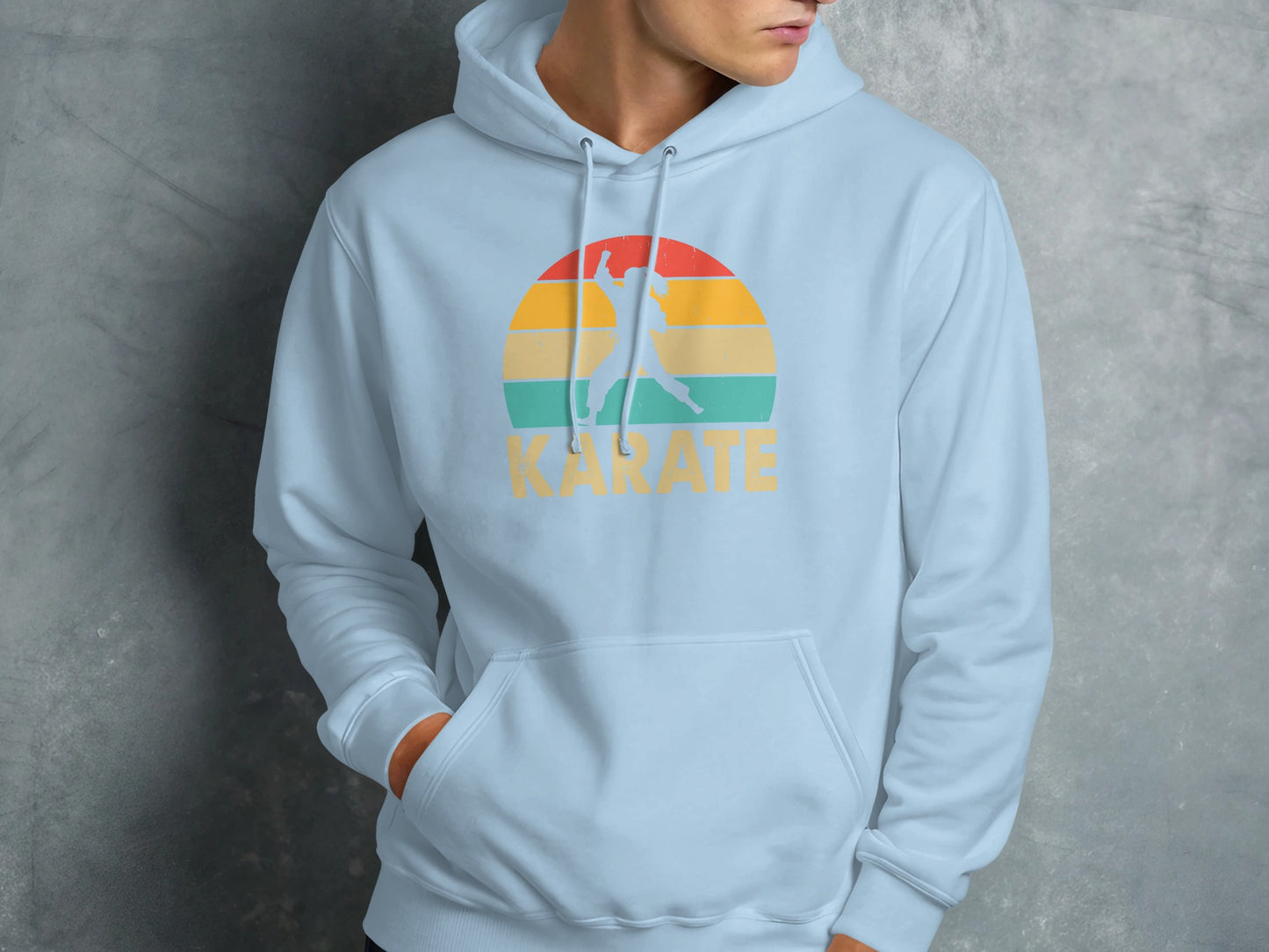 Light blue hoodie with a retro-style sunset logo and "Karate" text.