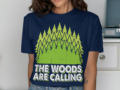 Navy t-shirt with green pine trees and text reading "The Woods Are Calling."