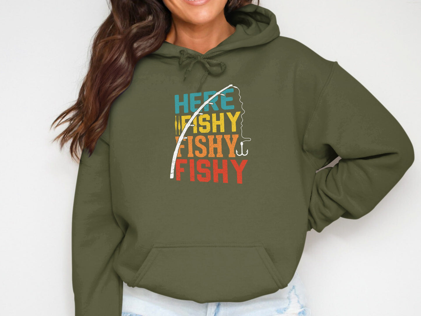 Olive green hoodie with colorful "Here Washy Fishy Fishy" text and fishing pole graphic.