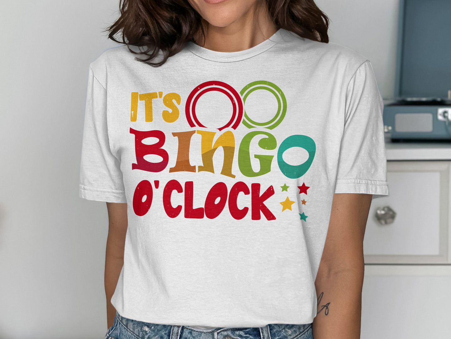 White t-shirt with "It's Bingo O'Clock" in colorful block letters.