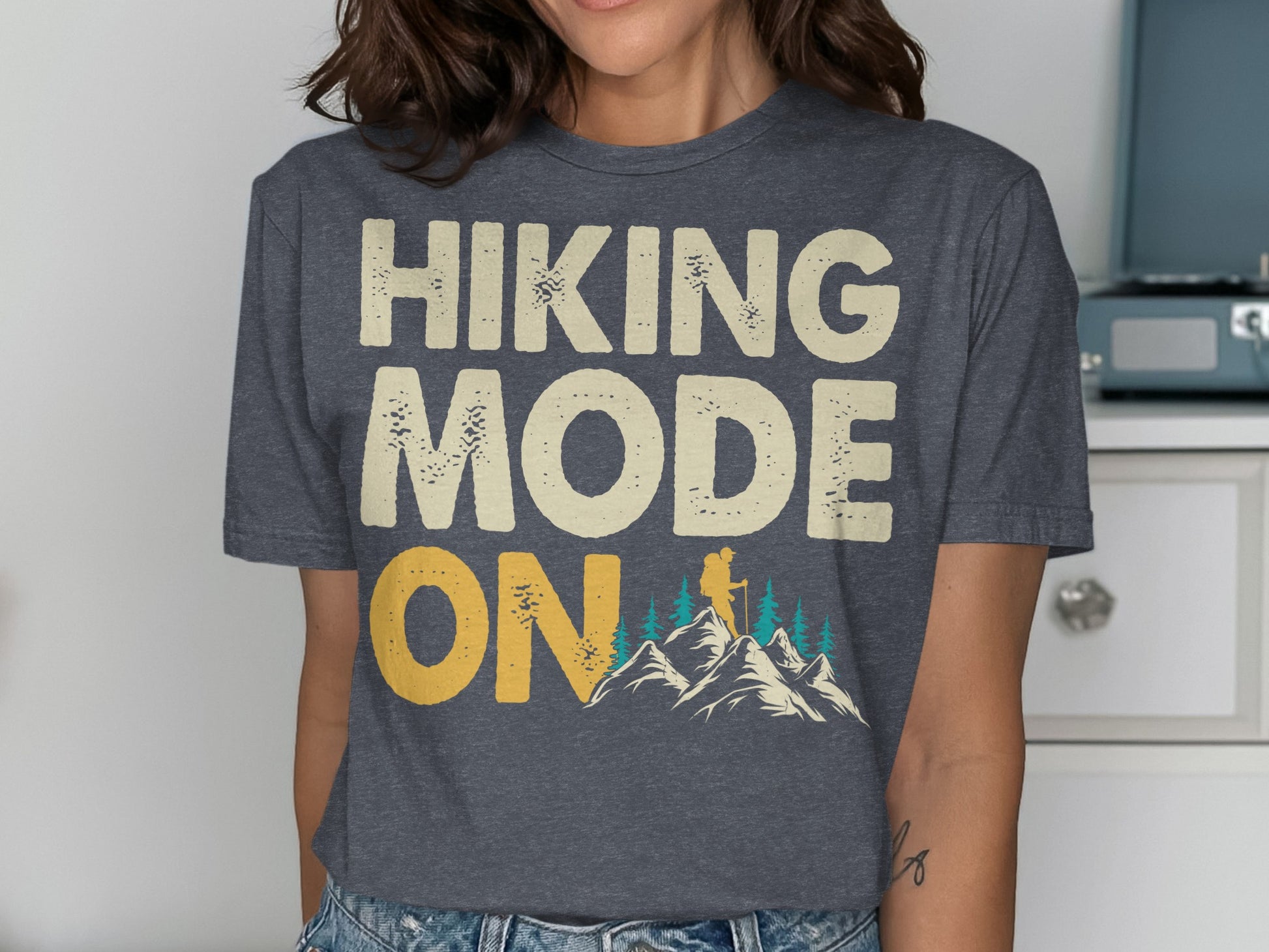 Dark grey t-shirt with "HIKING MODE ON" text and mountain graphic.