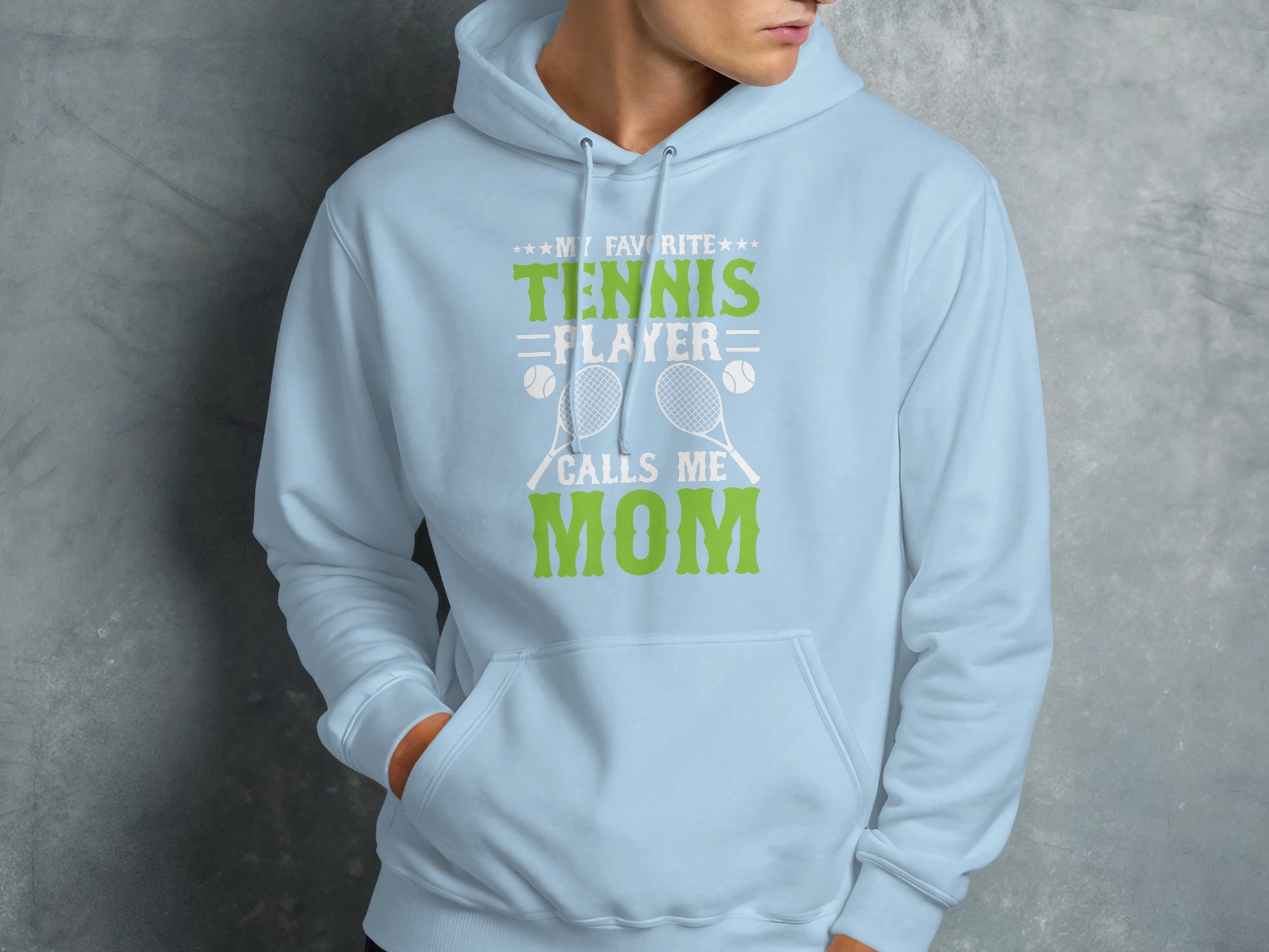 Light blue hoodie with "My Favorite Tennis Player Calls Me Mom" text and graphics.