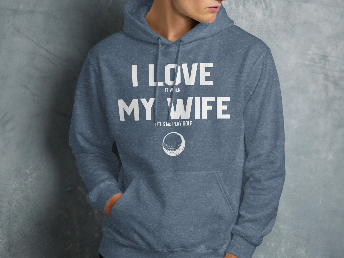 Blue hoodie with white text "I love it when my wife lets me play golf" and a golf ball graphic.
