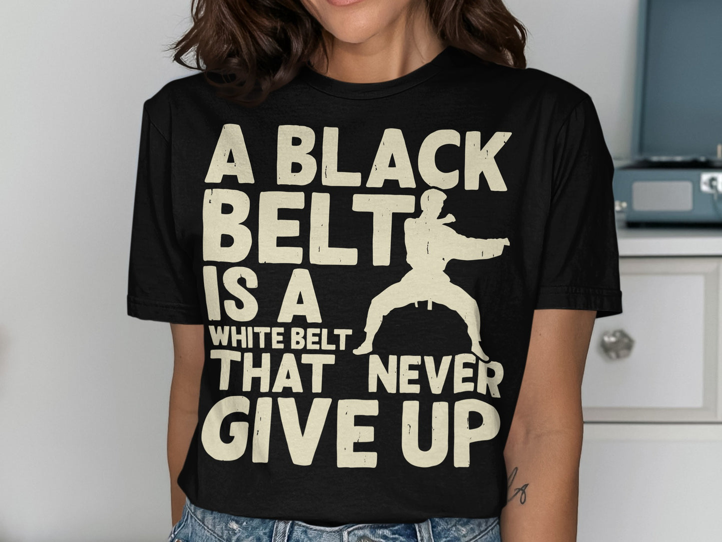 Black t-shirt with white text and a martial artist graphic.