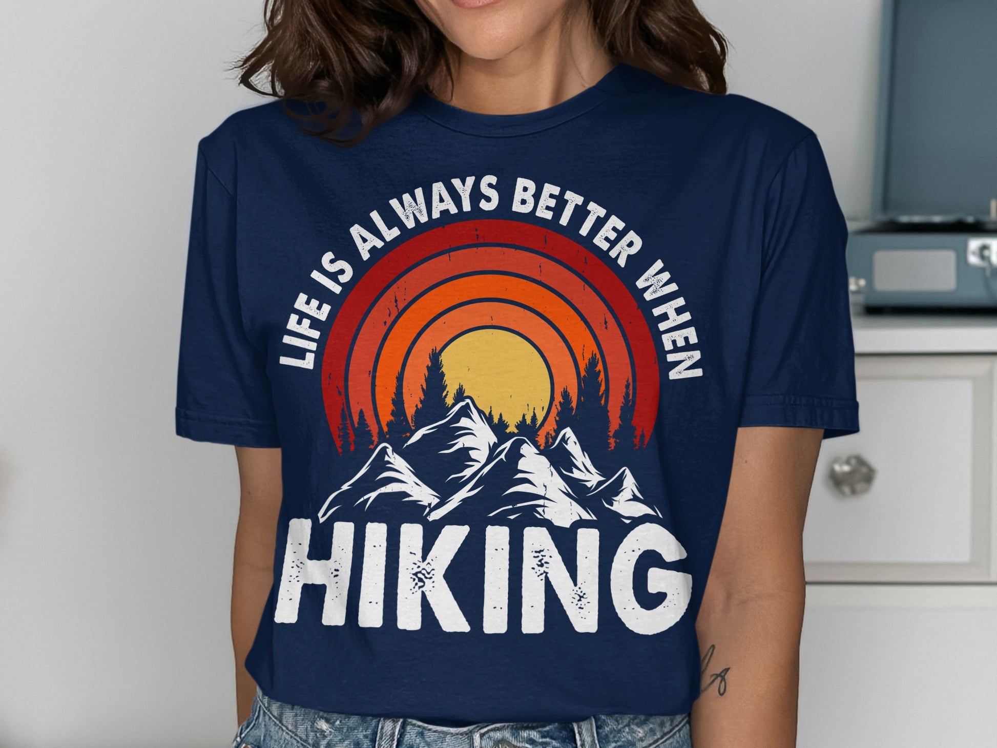 Navy t-shirt with "Life is Always Better When Hiking" and mountain sunset graphic.