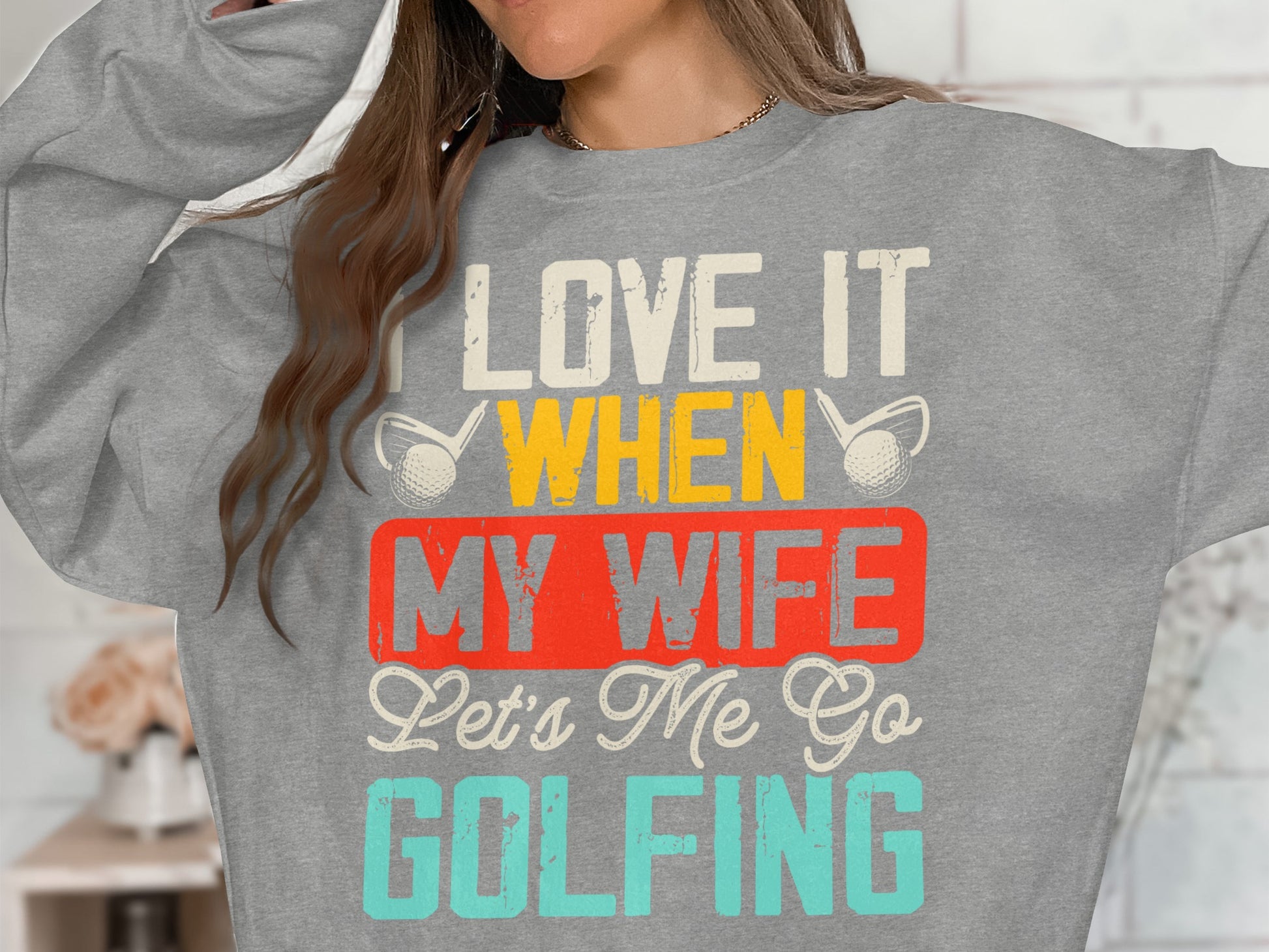 Gray sweatshirt with "I Love It When My Wife Lets Me Go Golfing" text.