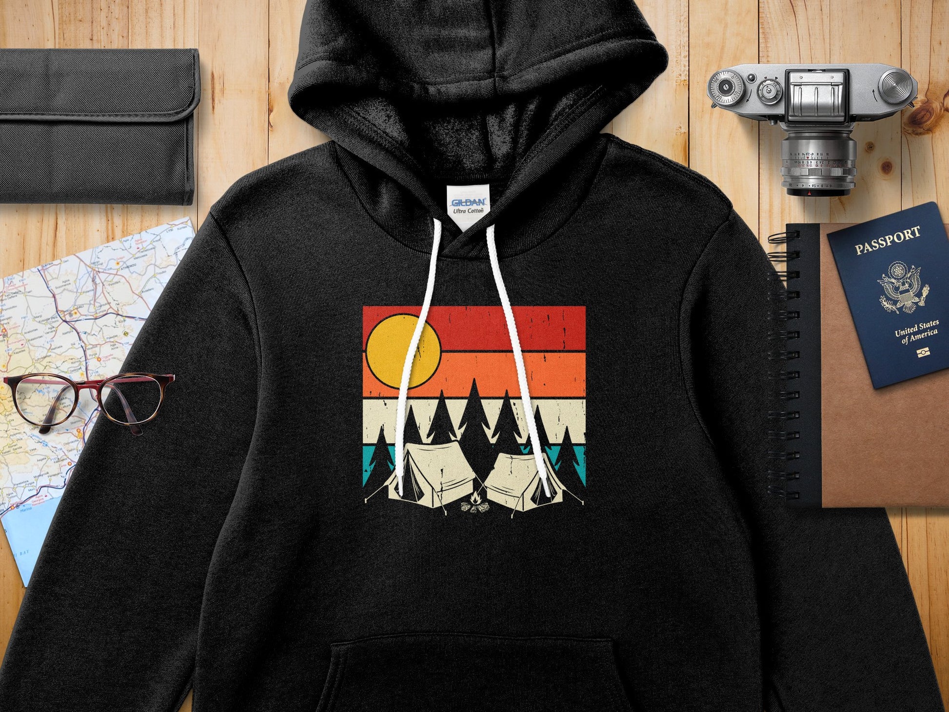 Black hoodie with a graphic of tents and a sunset.