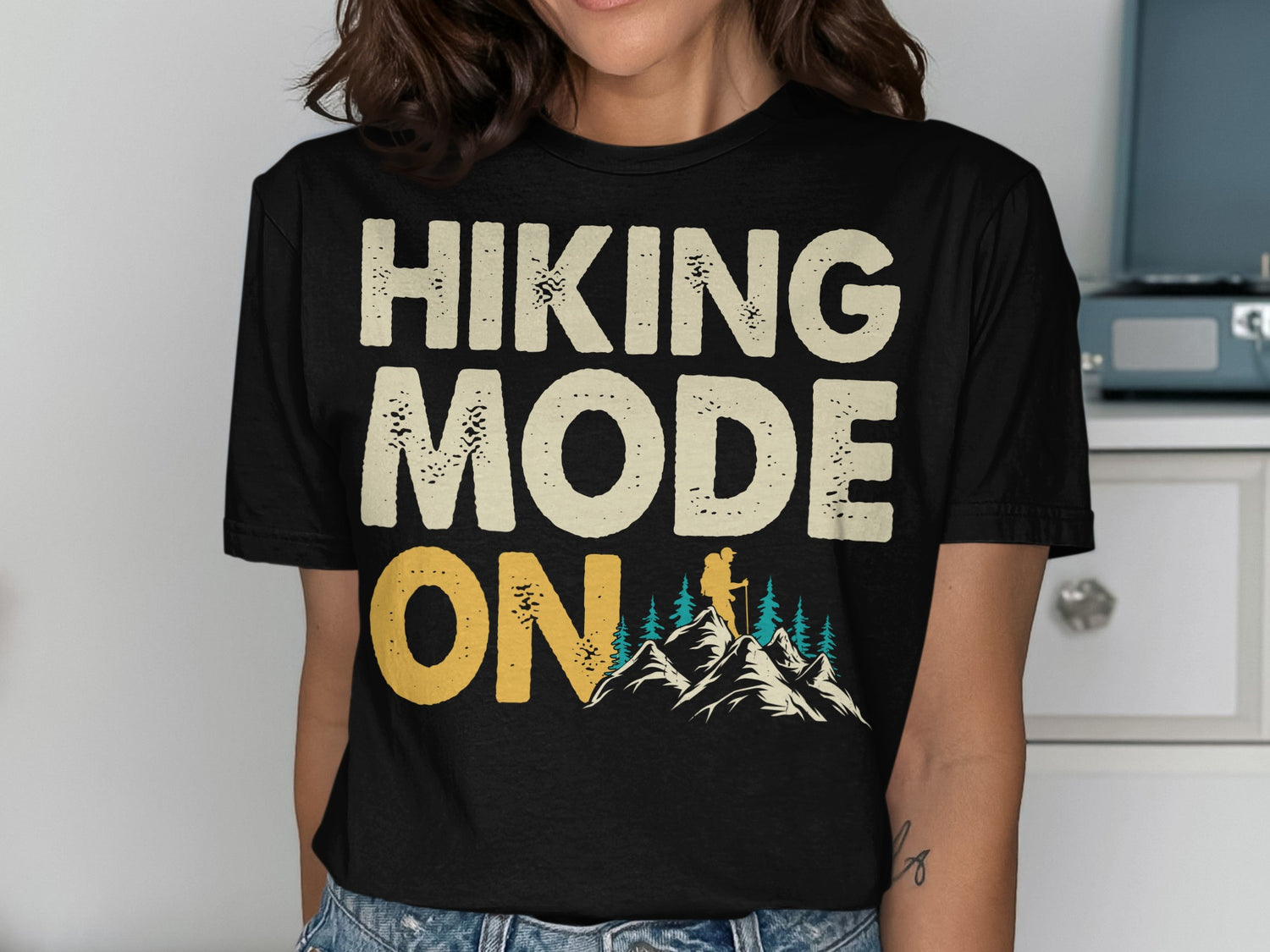 Black t-shirt with "Hiking Mode On" text and mountain graphic.