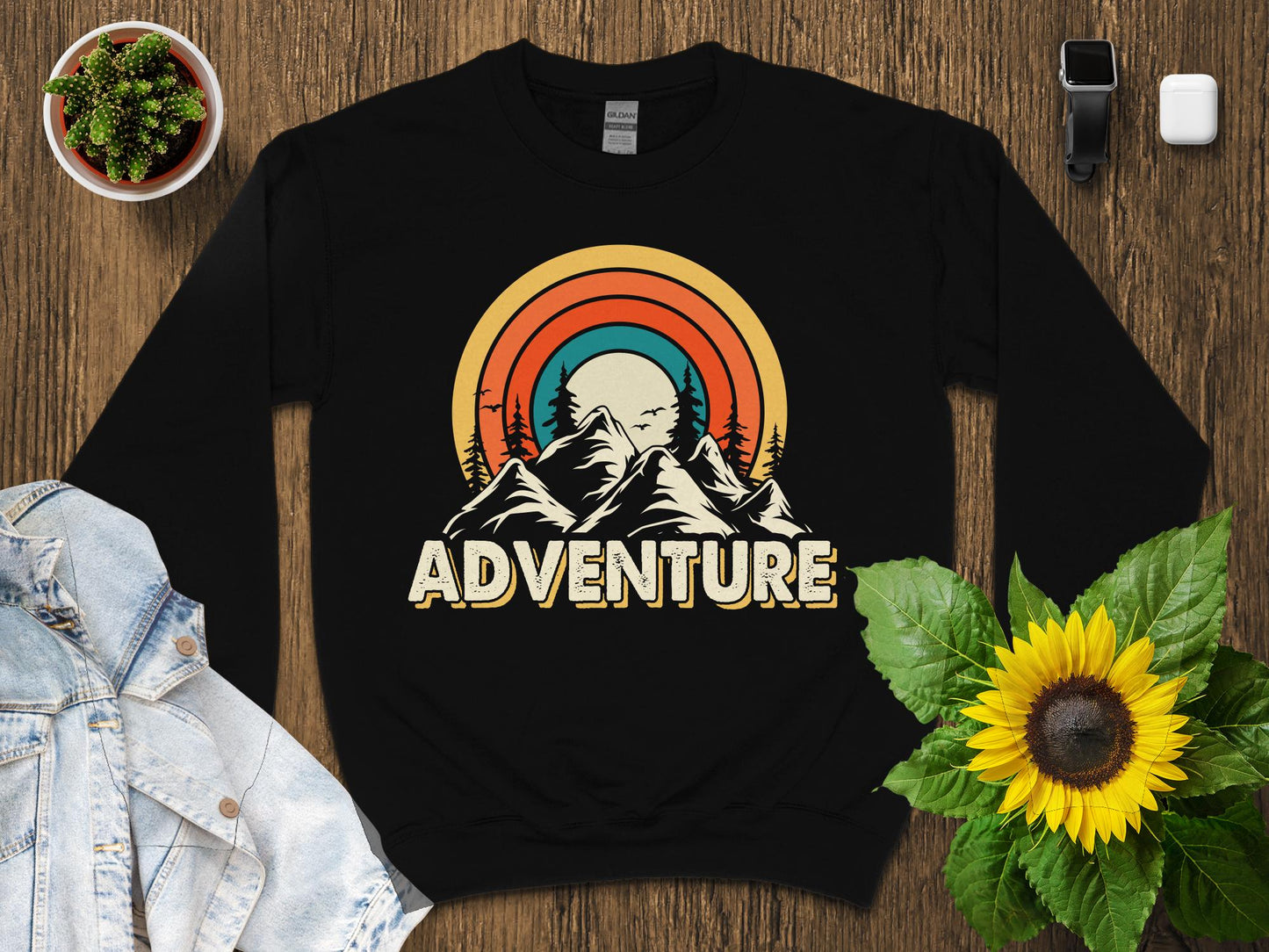 Retro sunset mountains graphic on a black crewneck sweatshirt.