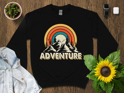 Retro sunset mountains graphic on a black crewneck sweatshirt.