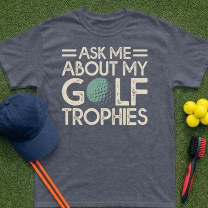 Dark grey t-shirt with "Ask me about my golf trophies" and a golf ball graphic.
