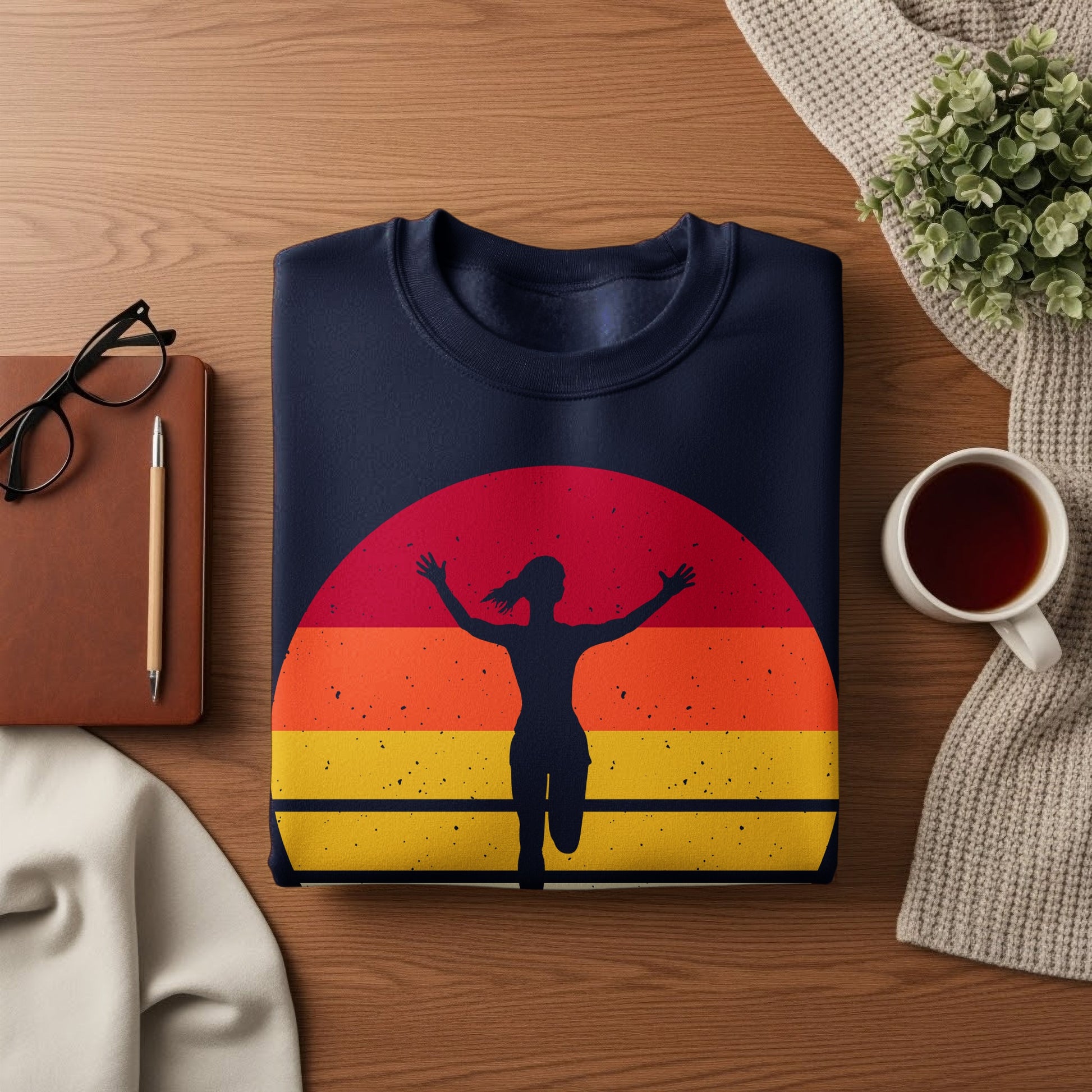 Navy sweatshirt with runner silhouette against a sunset graphic.