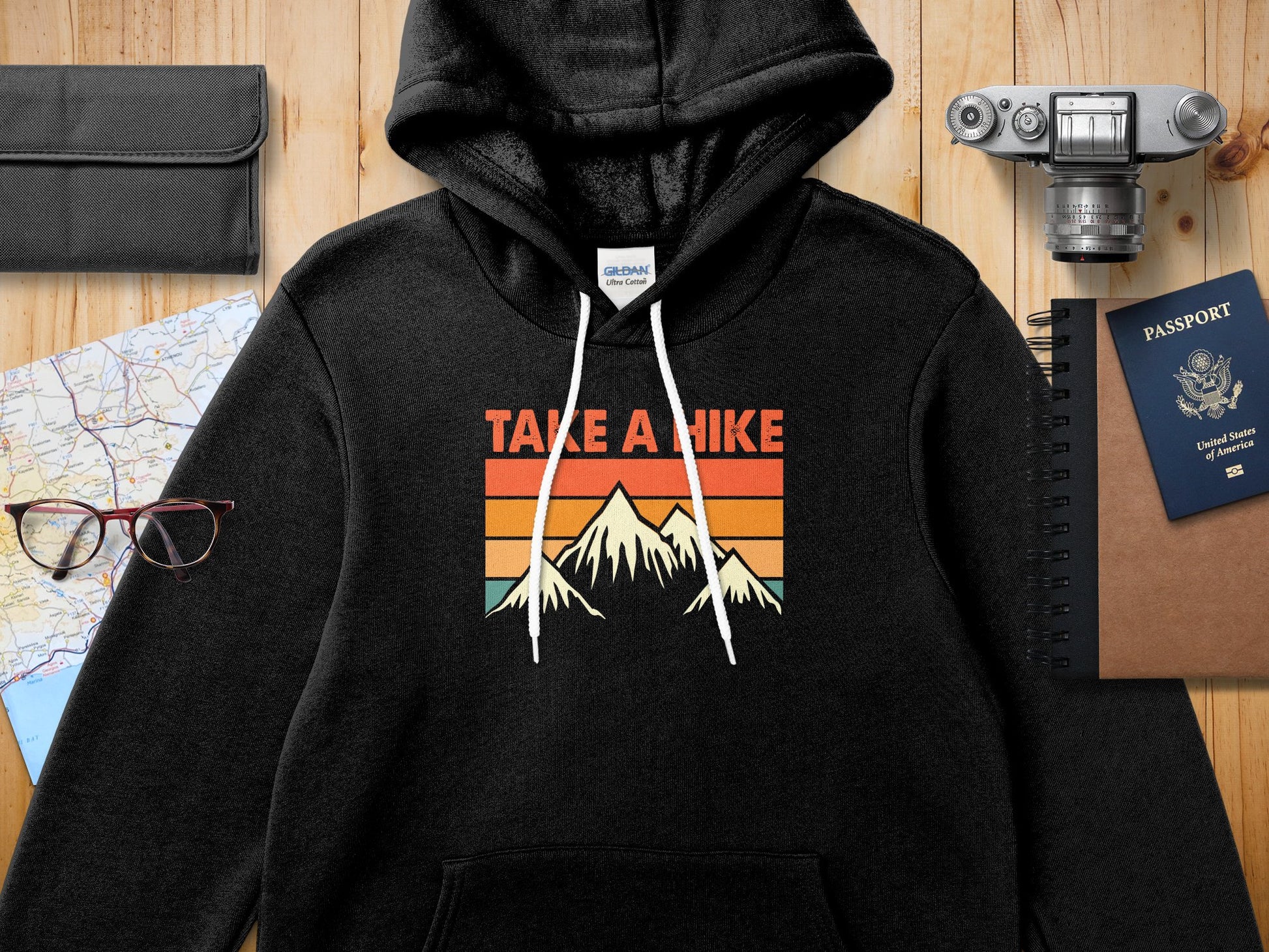 Black hoodie with "TAKE A HIKE" text and mountain graphic.