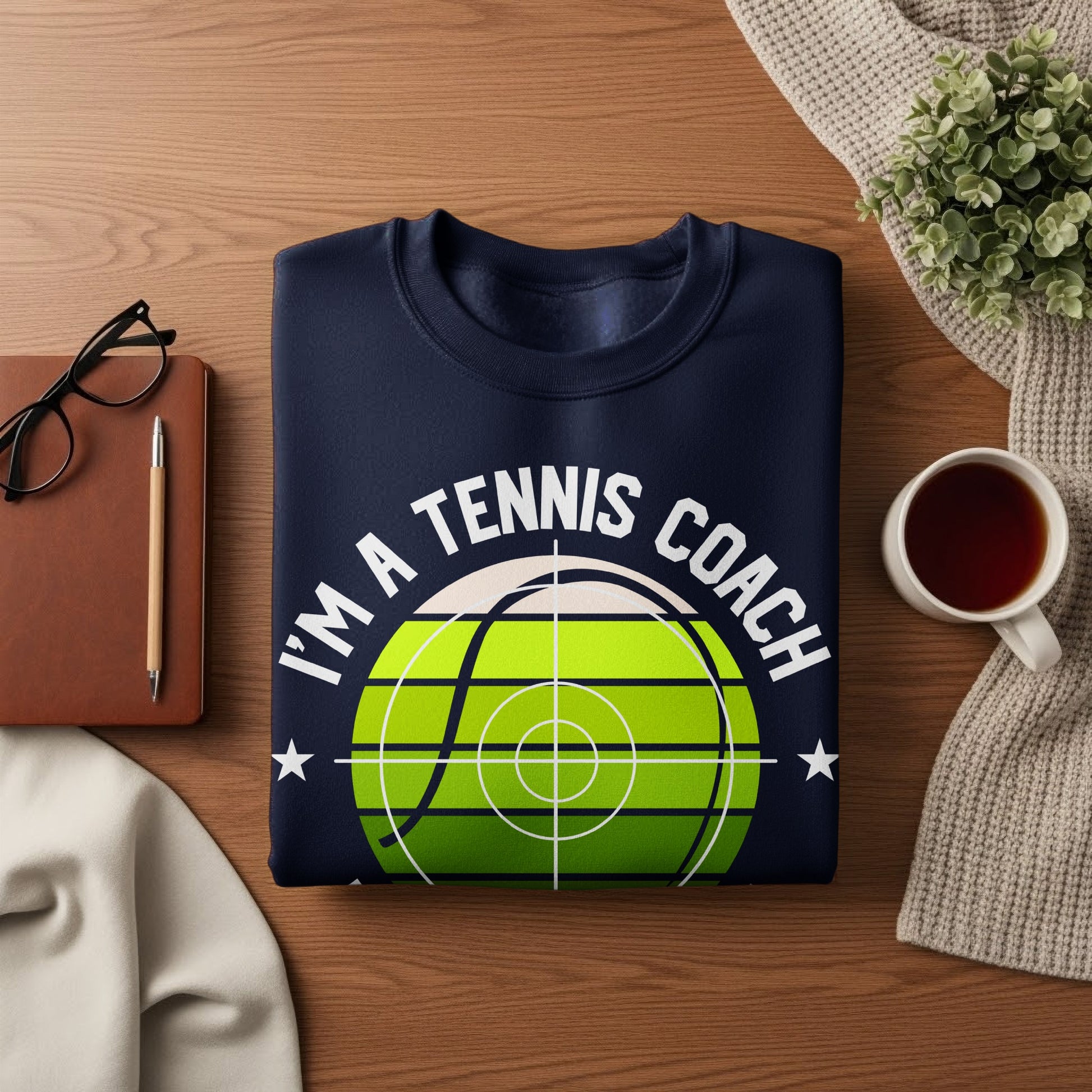 Navy sweatshirt with "I'm a tennis coach" text and a tennis ball graphic.