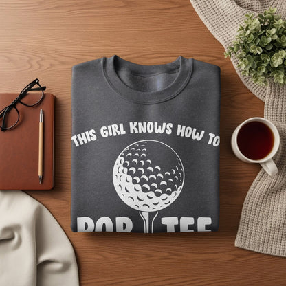 Dark gray sweatshirt with white text and golf ball graphic.