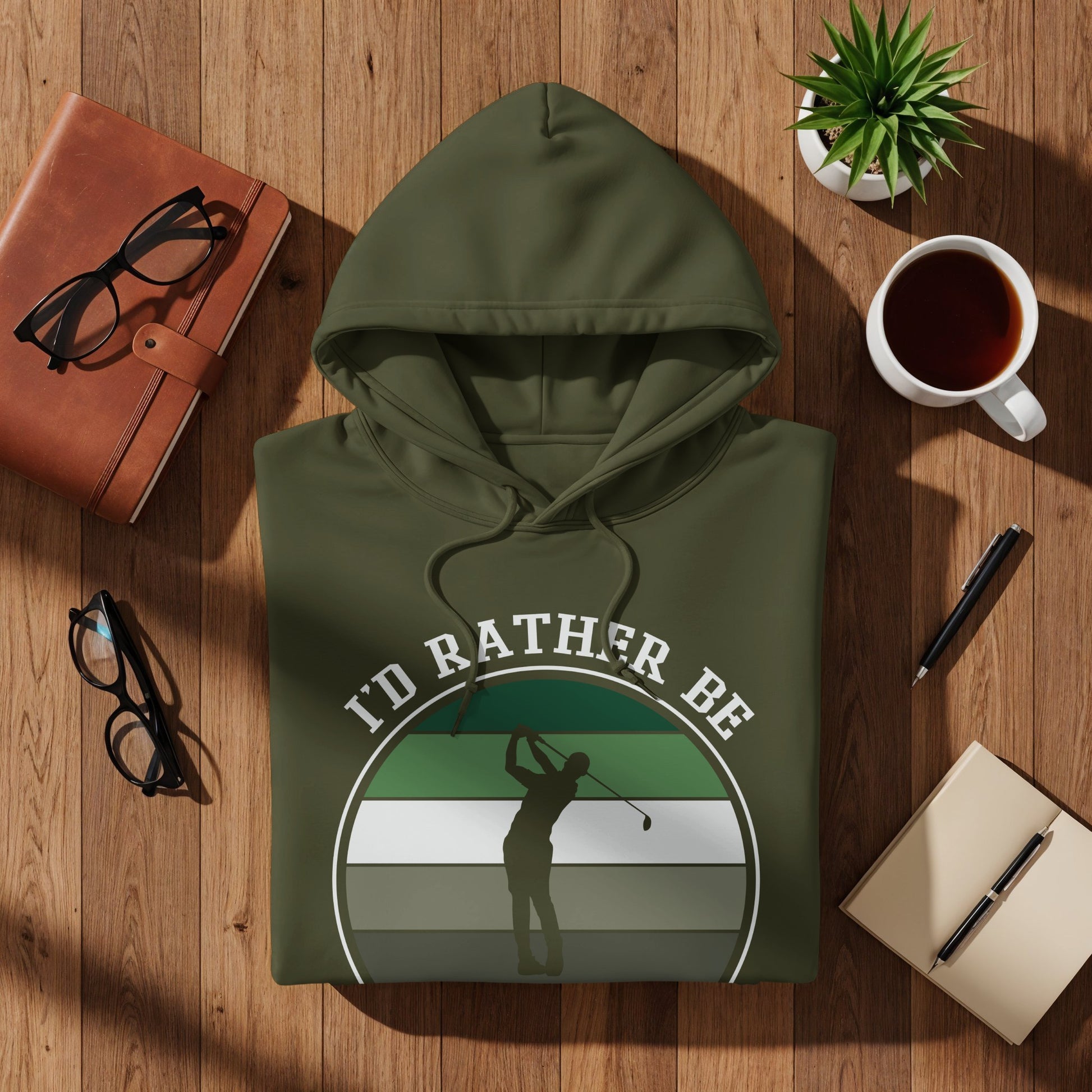 Olive green hoodie with graphic of golfer and text "I'd Rather Be".