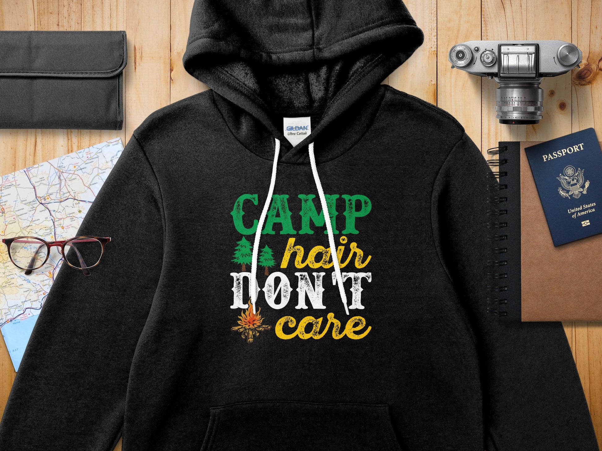 Black Gildan hoodie with "CAMP hair DON'T care" text and pine tree graphic.