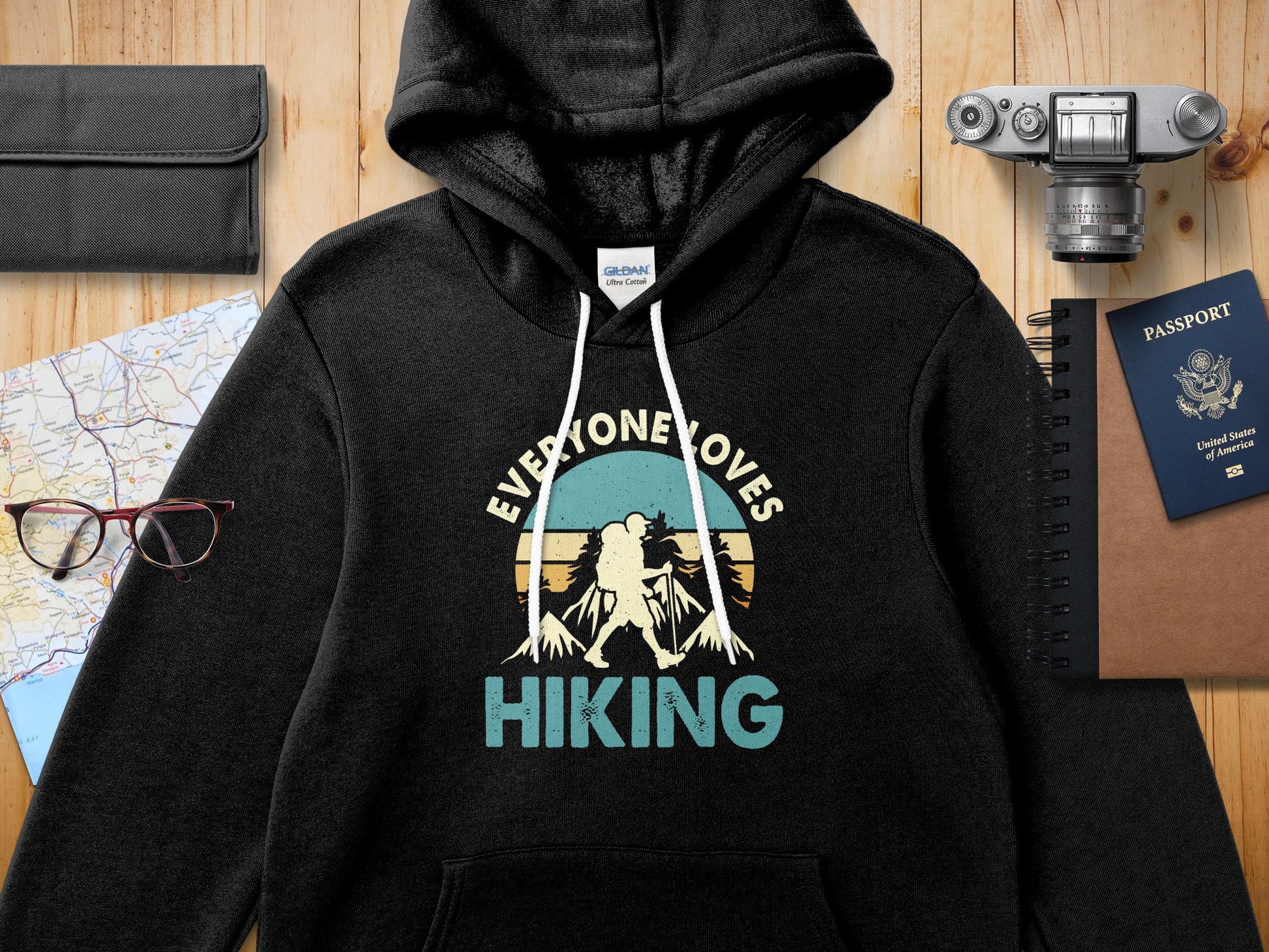 Black hoodie with "Everyone Loves Hiking" text and mountain graphic.