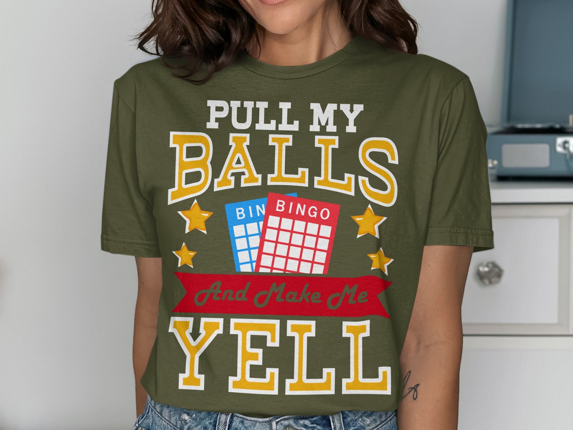 Olive green t-shirt with "Pull My Balls And Make Me Yell" text and bingo cards.