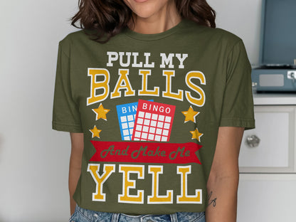 Olive green t-shirt with "Pull My Balls And Make Me Yell" text and bingo cards.