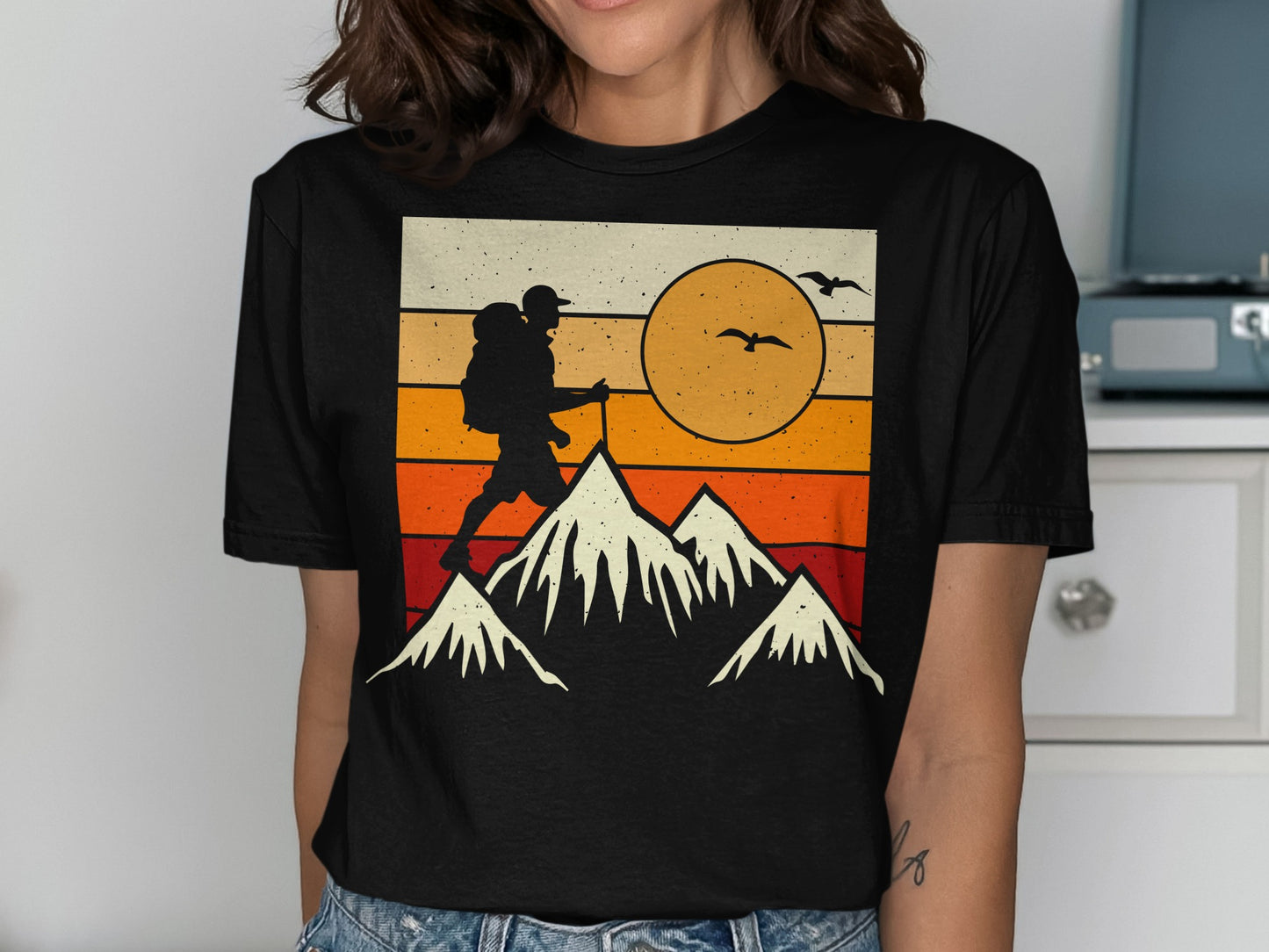 Silhouette of hiker with backpack hiking on mountain against sunset.