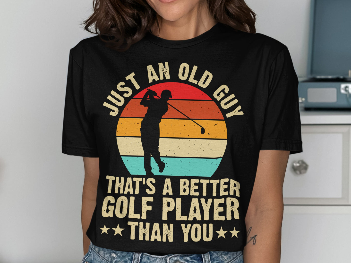 Black t-shirt with "Just An Old Guy That's A Better Golf Player Than You" text and golfer silhouette.