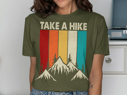 Green t-shirt with colorful stripes and mountains reading "TAKE A HIKE".