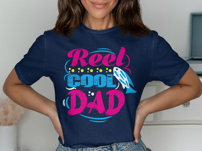 Navy t-shirt with "Reel Cool Dad" text, fish, and polka dots.