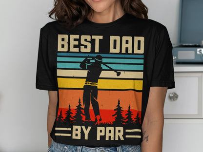 Black t-shirt with "BEST DAD BY PAR" text and golfer silhouette against striped sunset.