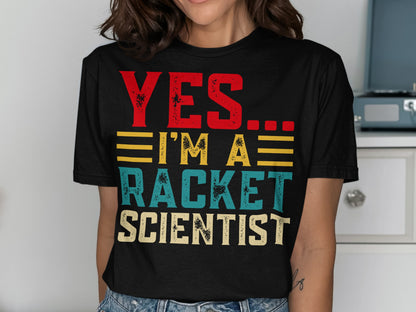 Black t-shirt with red, yellow, and blue text reading "YES. I'M A RACKET SCIENTIST."