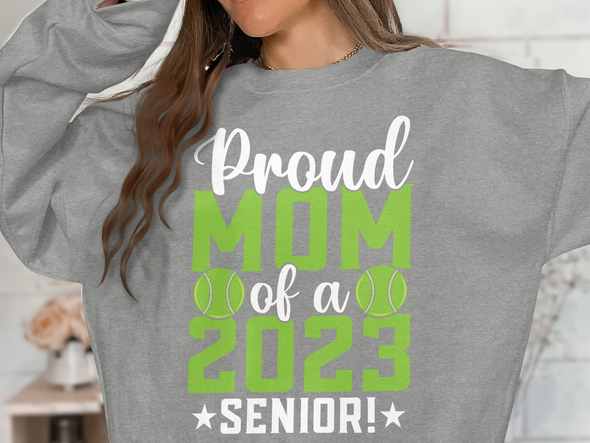 Grey sweatshirt with "Proud MOM of a SENIOR! 2023" and tennis balls.