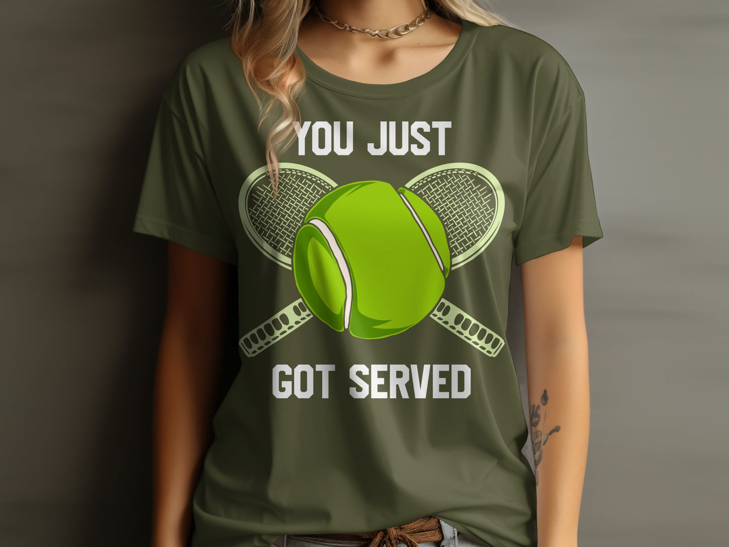 Green t-shirt with text "YOU JUST GOT SERVED" and tennis ball and rackets.