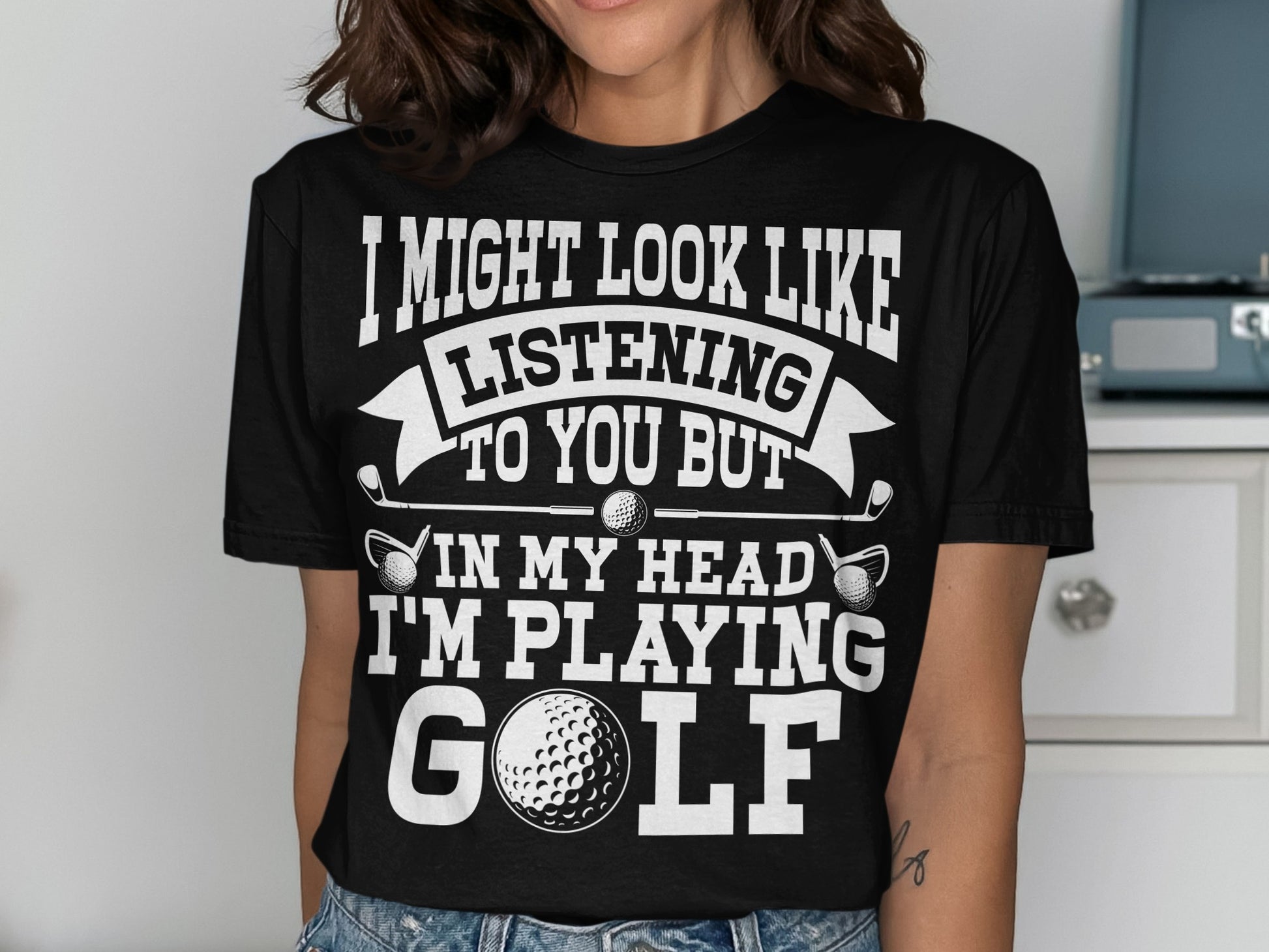 Black t-shirt with white text and golf imagery, saying "I'm playing golf".