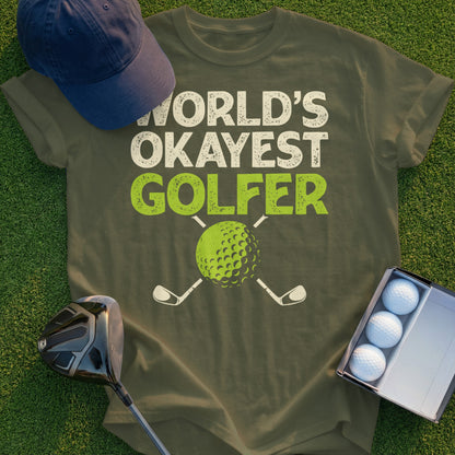Olive t-shirt with "World's Okayest Golfer" text and a golf ball.