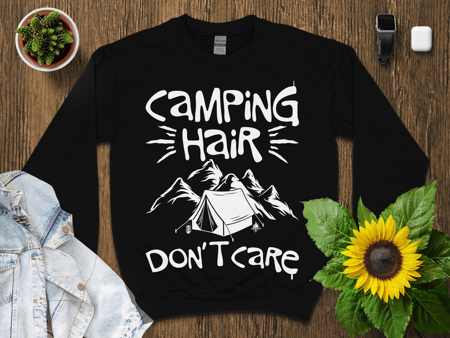 Black sweatshirt with "Camping Hair Don't Care" text and mountain graphic.