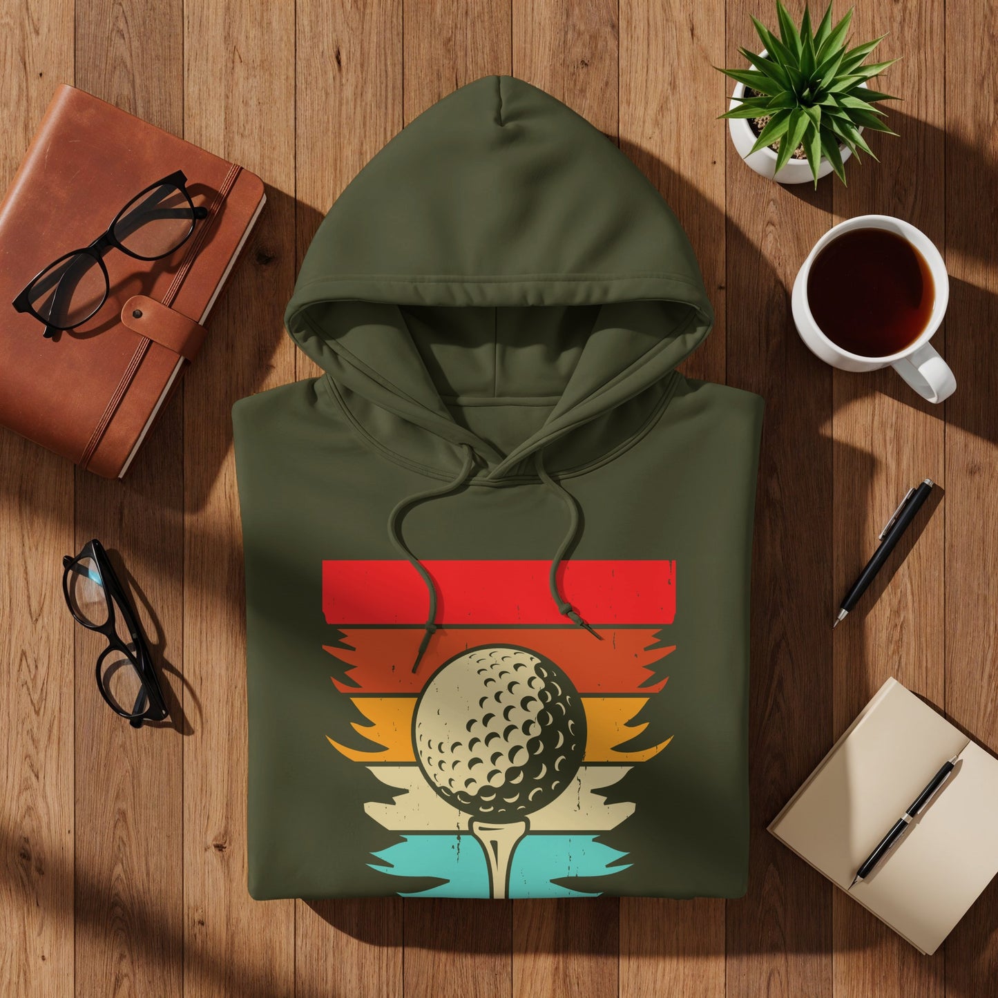 Olive green hoodie with a vintage golf ball on a tee graphic.