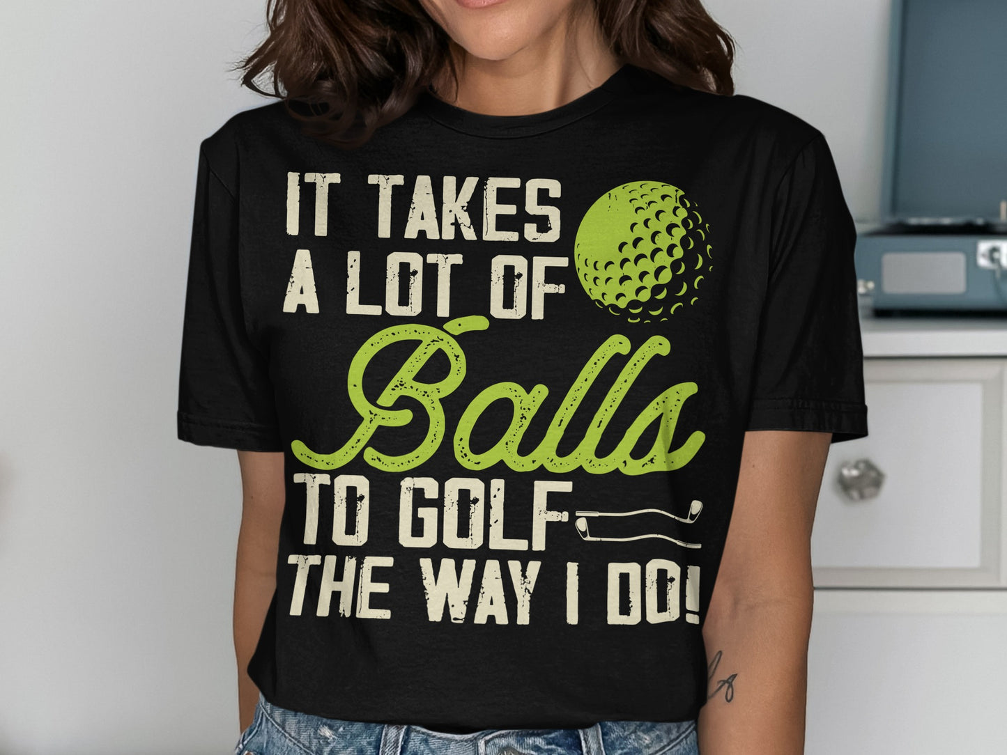 Black t-shirt with "It Takes a Lot of Balls to Golf the Way I Do!" text.