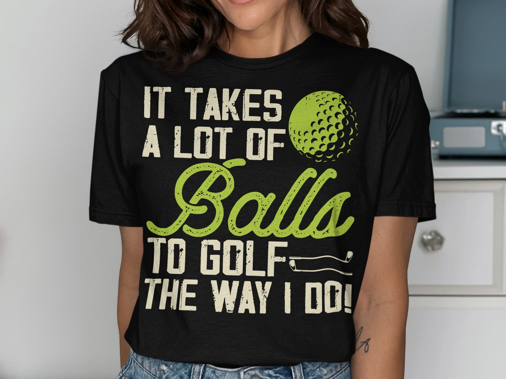 Black t-shirt with "It Takes a Lot of Balls to Golf the Way I Do!" text.