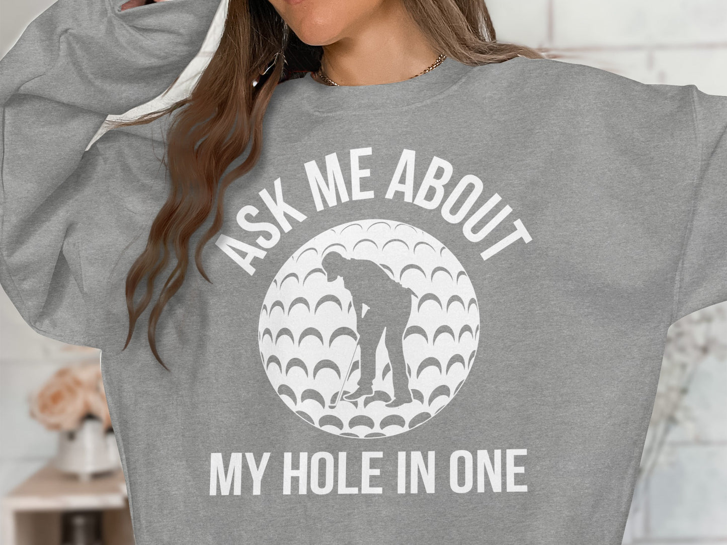 Gray sweatshirt with a graphic of a golfer and "Ask Me About My Hole In One" text.