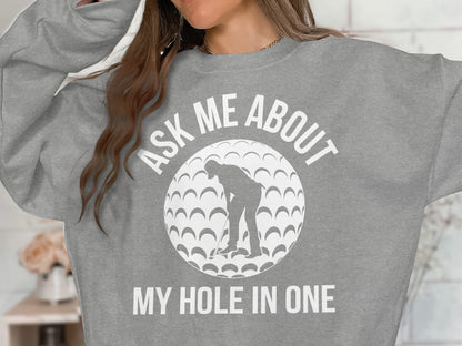 Gray sweatshirt with a graphic of a golfer and "Ask Me About My Hole In One" text.