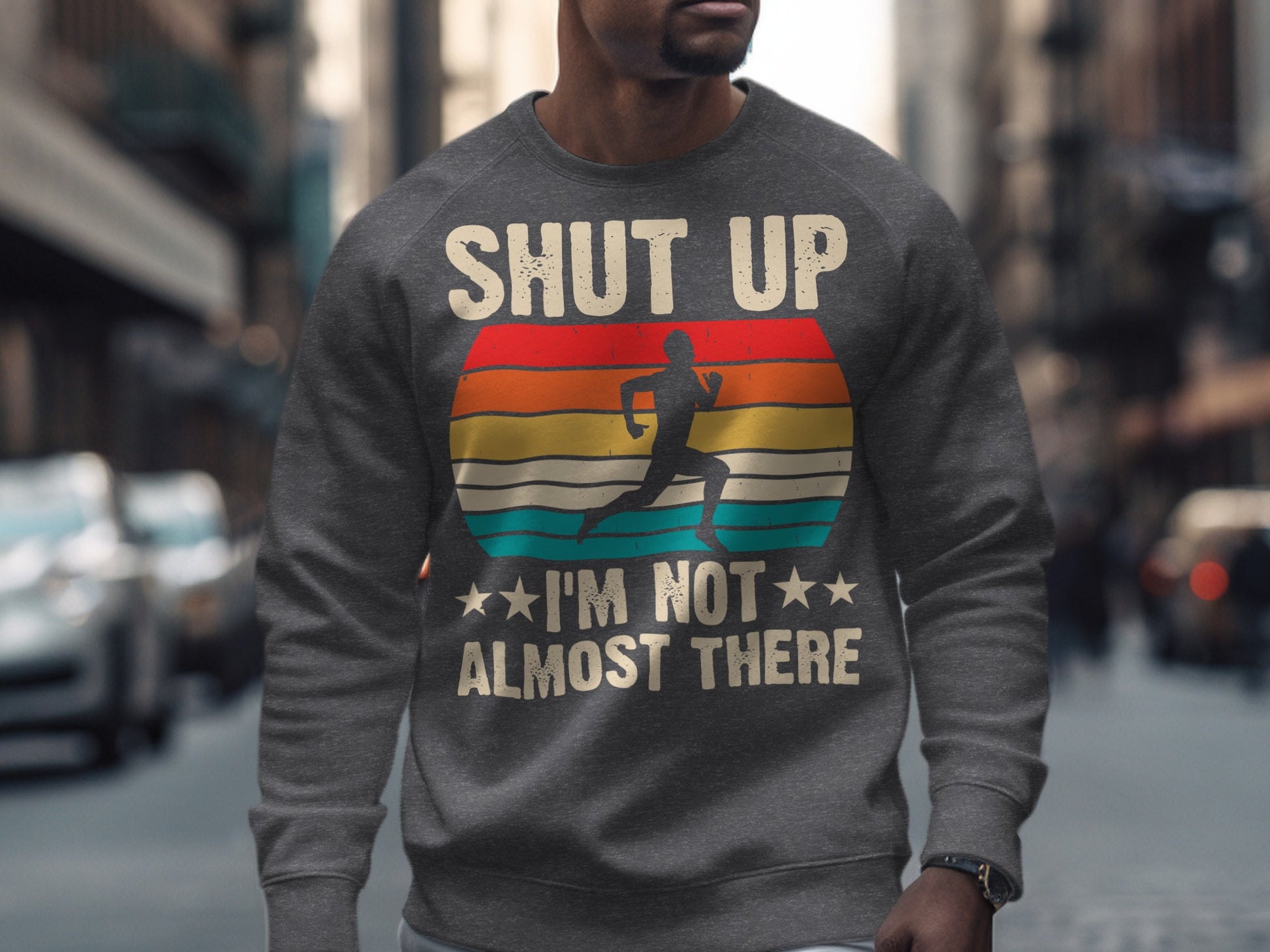 Gray sweatshirt with text "SHUT UP I'M NOT ALMOST THERE" and runner silhouette.