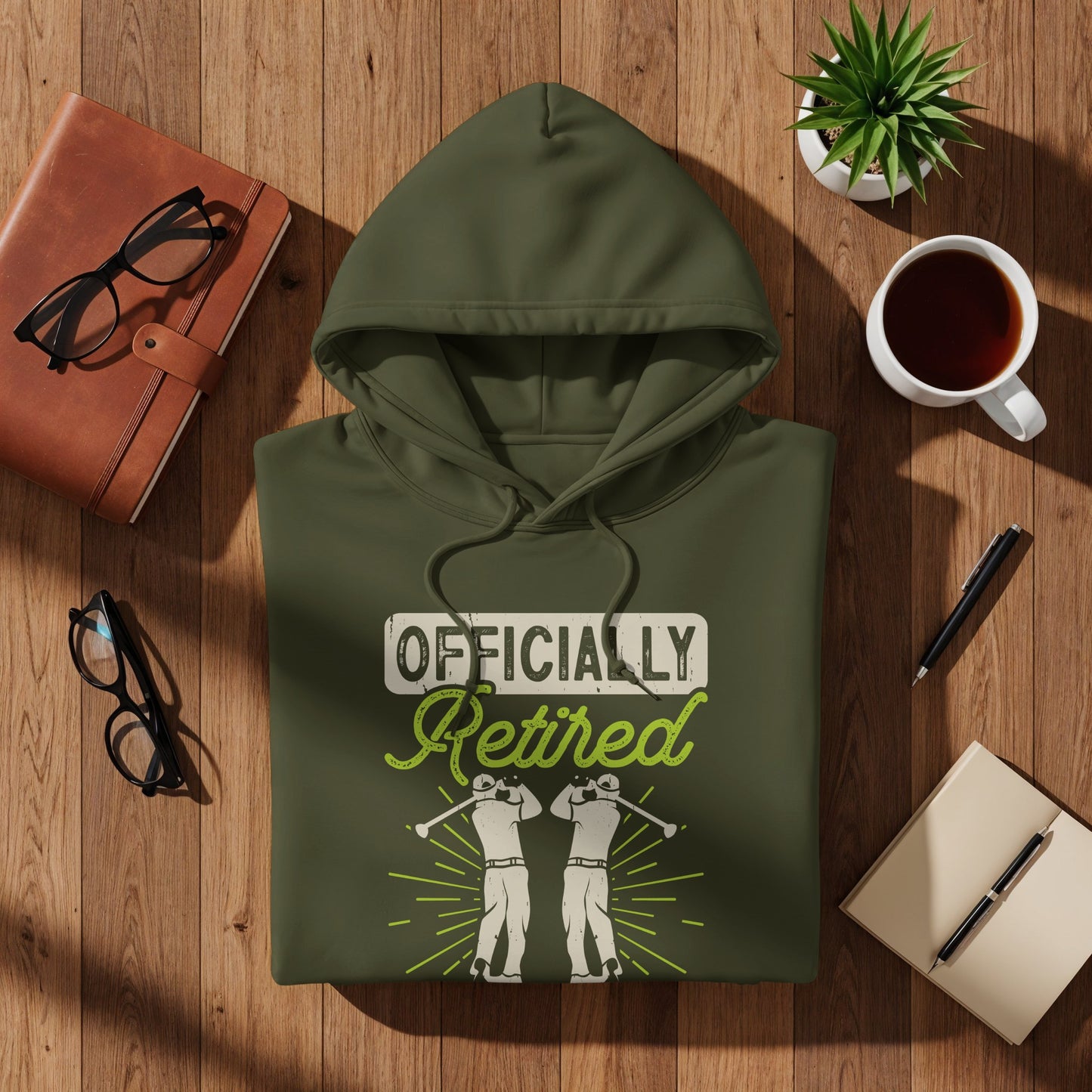 Olive green hoodie with "Officially Retired" text and golfer graphics.