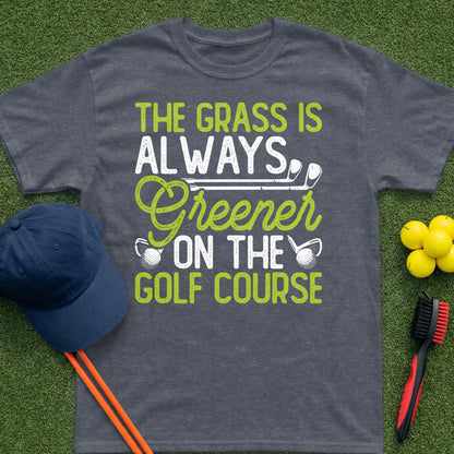 Dark t-shirt with white and green text that reads "The grass is always greener on the golf course."