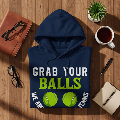 Navy blue hoodie with "Grab Your Balls We Are Tennis" text and two tennis balls.