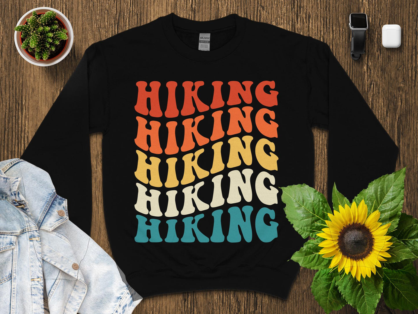 Black sweatshirt with "Hiking" repeated in colorful retro font.
