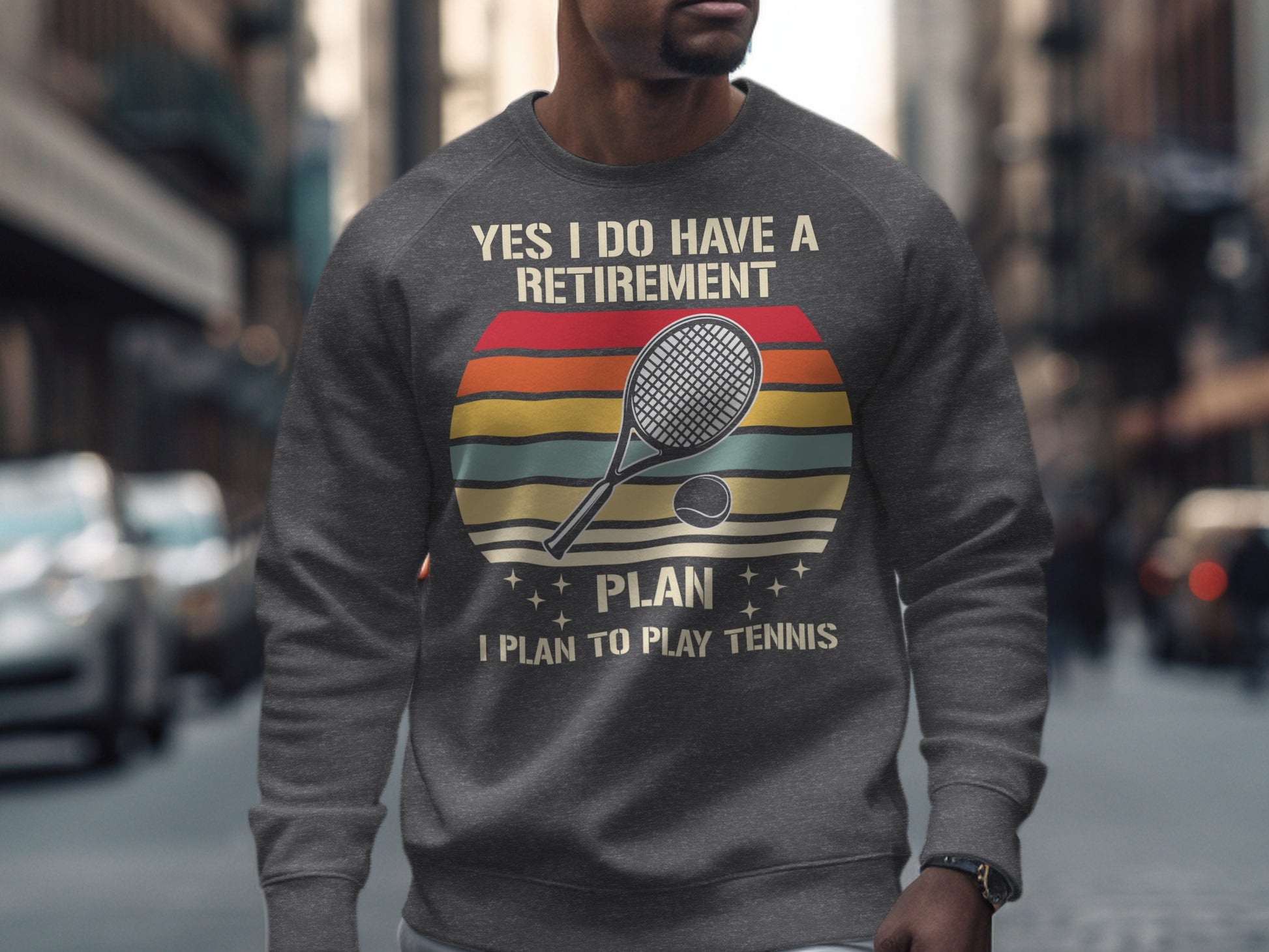 Gray sweatshirt with "YES I DO HAVE A RETIREMENT PLAN I PLAN TO PLAY TENNIS" text and tennis racket.
