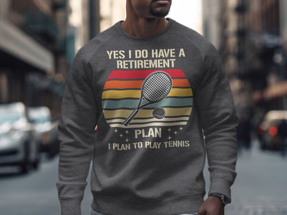 Gray sweatshirt with "YES I DO HAVE A RETIREMENT PLAN I PLAN TO PLAY TENNIS" text and tennis racket.