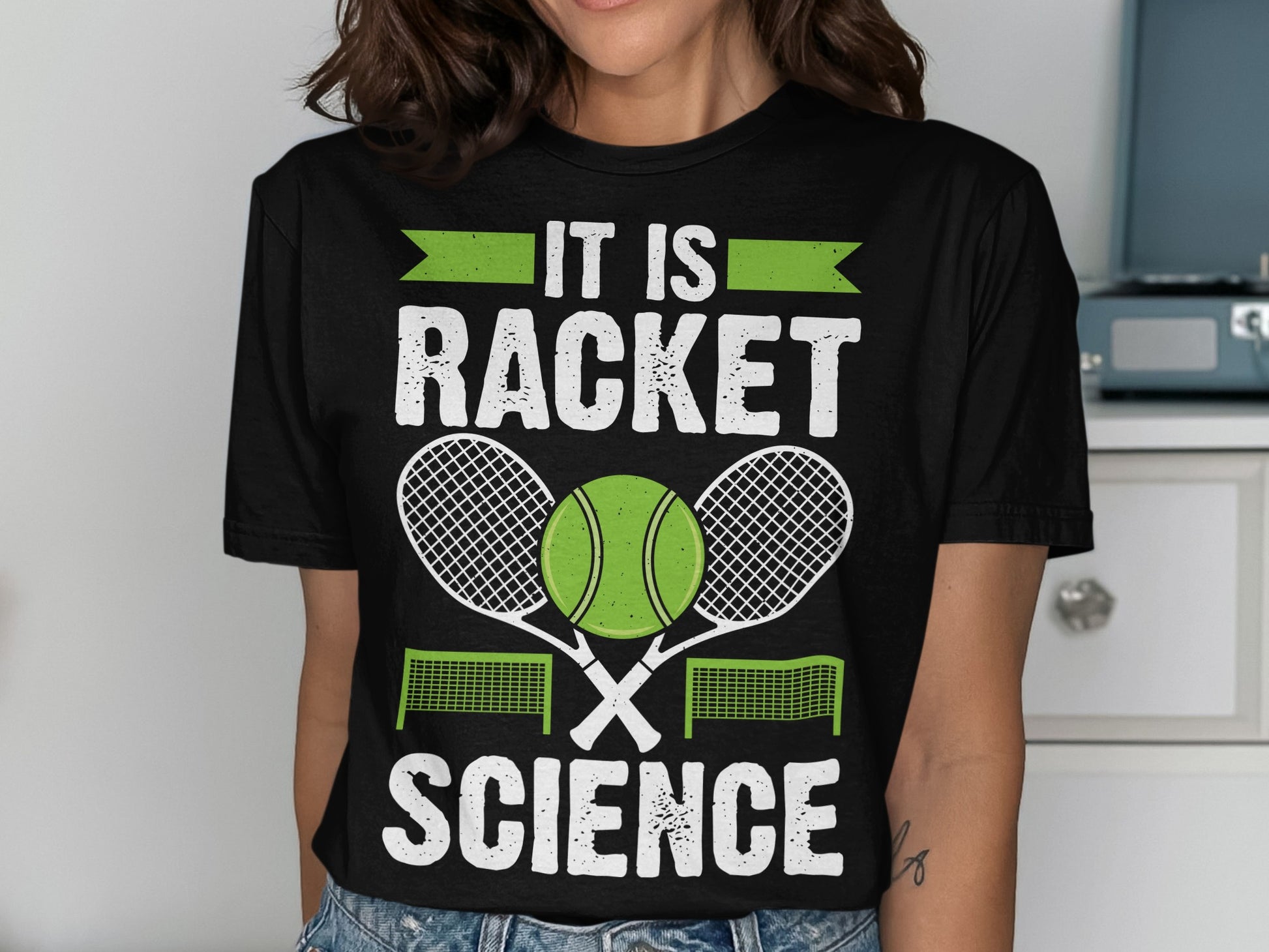 Black t-shirt with "IT IS RACKET SCIENCE" text, tennis ball, and rackets.